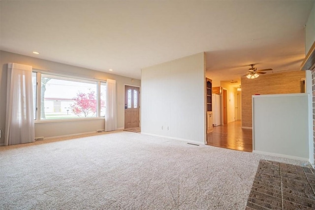 spare room with ceiling fan and carpet