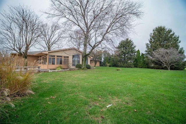 view of yard with a sunroom