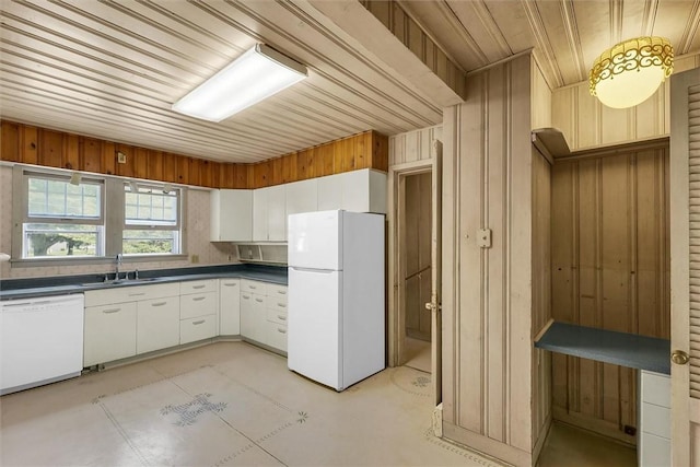 3920 Western Ave, Mattoon, IL 61938 - kitchen with white appliances, dark countertops, white cabinetry, wooden ceiling, and wood walls