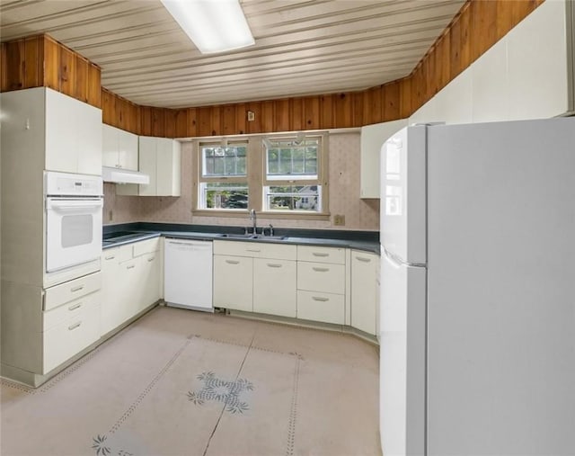 3920 Western Ave, Mattoon, IL 61938 - kitchen featuring white appliances, under cabinet range hood, healthy amount of natural light, dark countertops, and wood ceiling