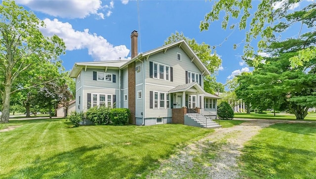 3920 Western Ave, Mattoon, IL 61938 - back of house featuring a chimney and a lawn