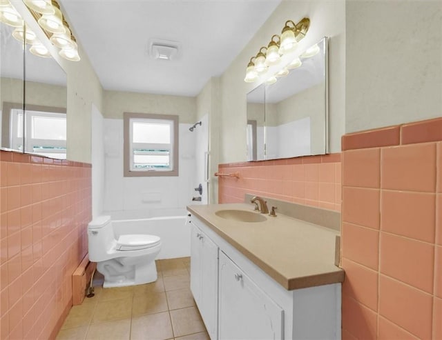 3920 Western Ave, Mattoon, IL 61938 - full bath featuring tile walls, tile patterned flooring, vanity, and washtub / shower combination