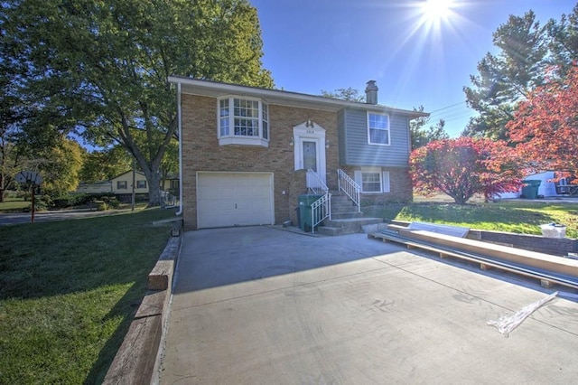 split foyer home with a front lawn and a garage