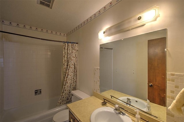 bathroom with vanity, toilet, shower / bath combo, and visible vents