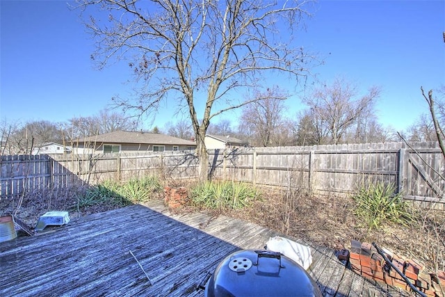 view of yard with a wooden deck and a fenced backyard