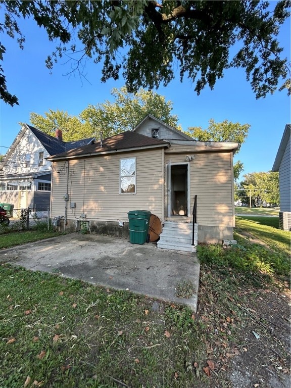 rear view of property with a yard and a patio