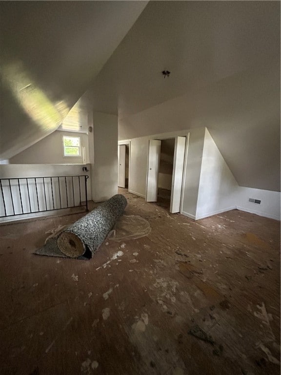 additional living space featuring vaulted ceiling