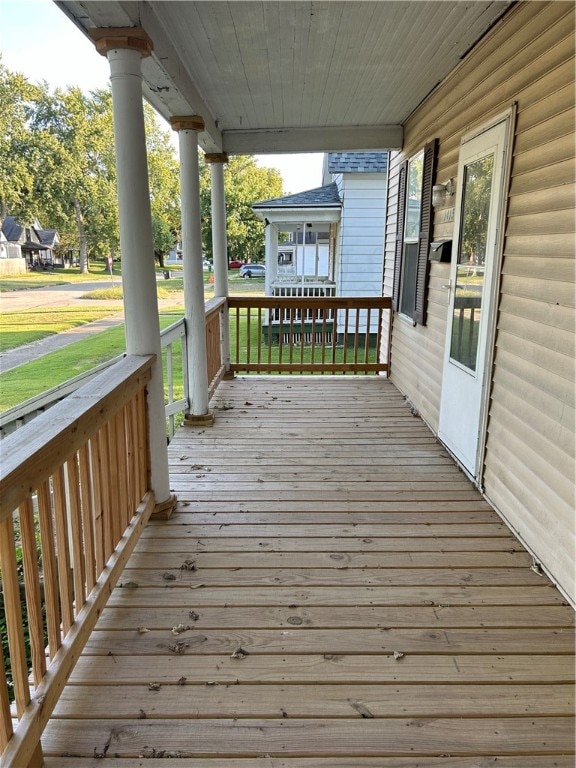 wooden terrace featuring covered porch