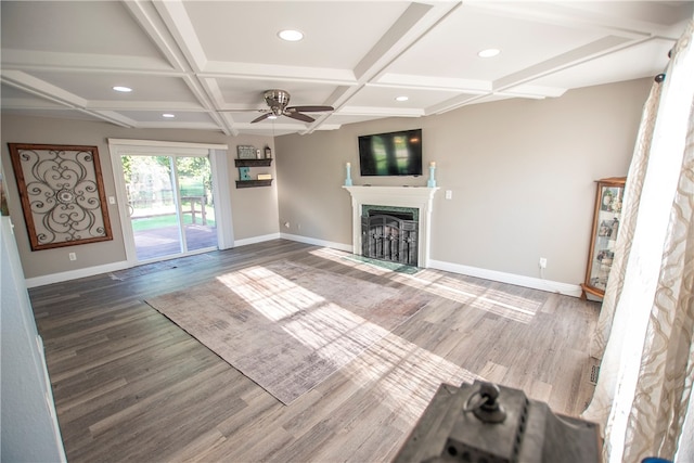 unfurnished living room with dark hardwood / wood-style floors, ceiling fan, and coffered ceiling