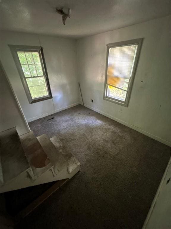 1159 Mueller Ave, Decatur, IL 62526 - spare room featuring dark colored carpet and baseboards