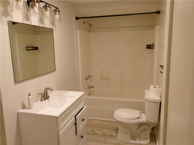 2004 Hayes Ave, Charleston, IL 61920 - full bathroom featuring vanity, toilet, wood finished floors, and bathtub / shower combination