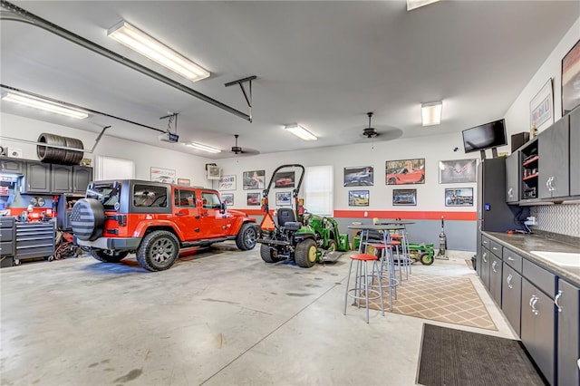 garage featuring a sink and a garage door opener