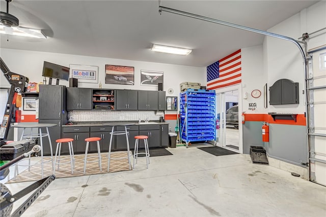 garage with a ceiling fan and freestanding refrigerator