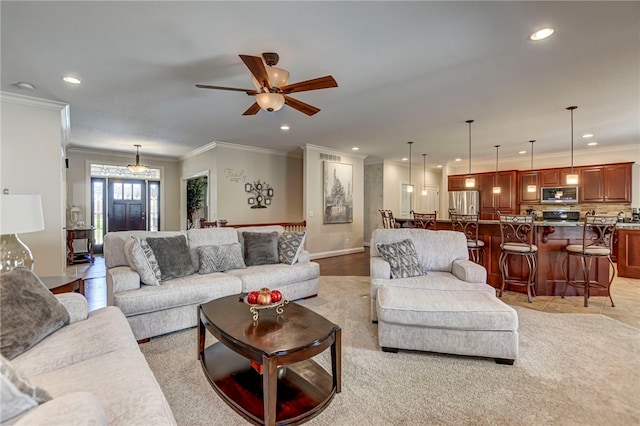 living area with recessed lighting, ceiling fan, and ornamental molding