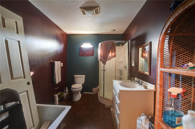 full bathroom featuring vanity, separate shower and tub, toilet, a textured ceiling, and wood-type flooring