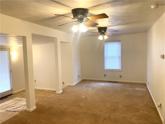 unfurnished room featuring light carpet