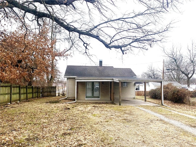 rear view of house featuring a carport