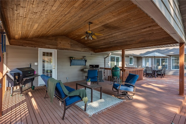 wooden deck featuring ceiling fan and a grill