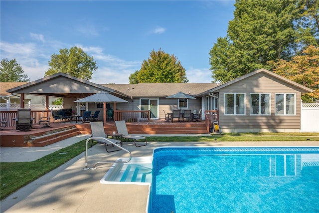 rear view of property featuring a patio and a pool side deck