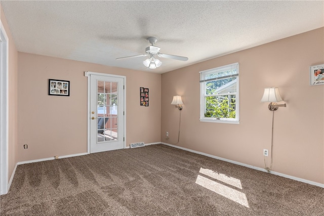 carpeted empty room with a textured ceiling and ceiling fan