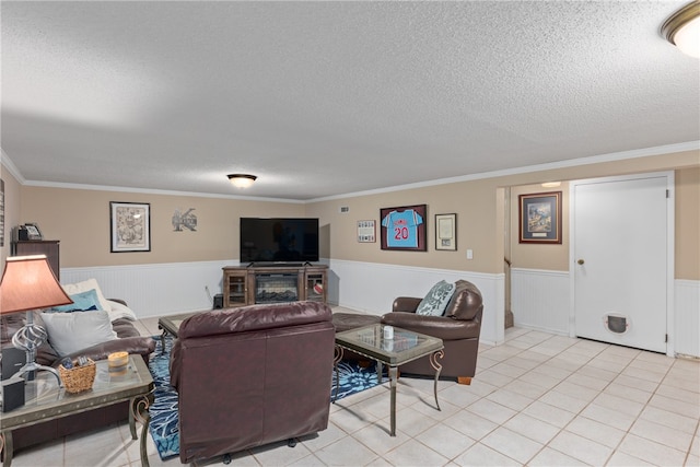 living room featuring crown molding, light tile patterned floors, and a textured ceiling