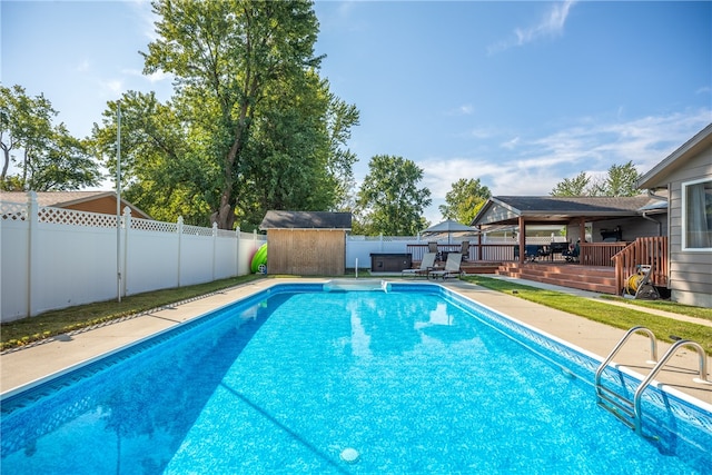 view of pool with a storage unit and a wooden deck