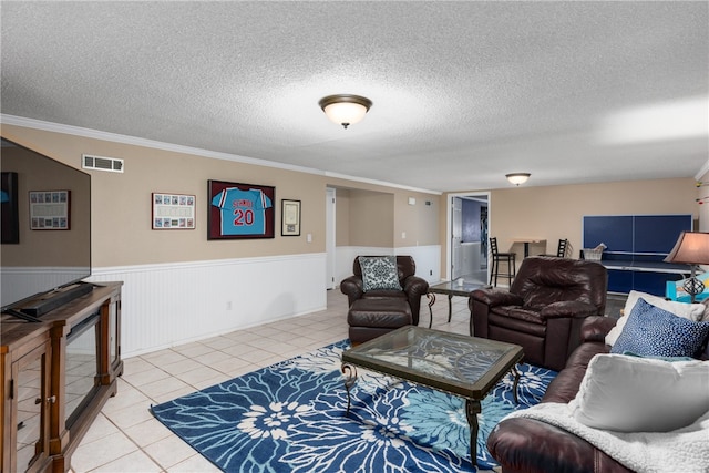 tiled living room with crown molding and a textured ceiling