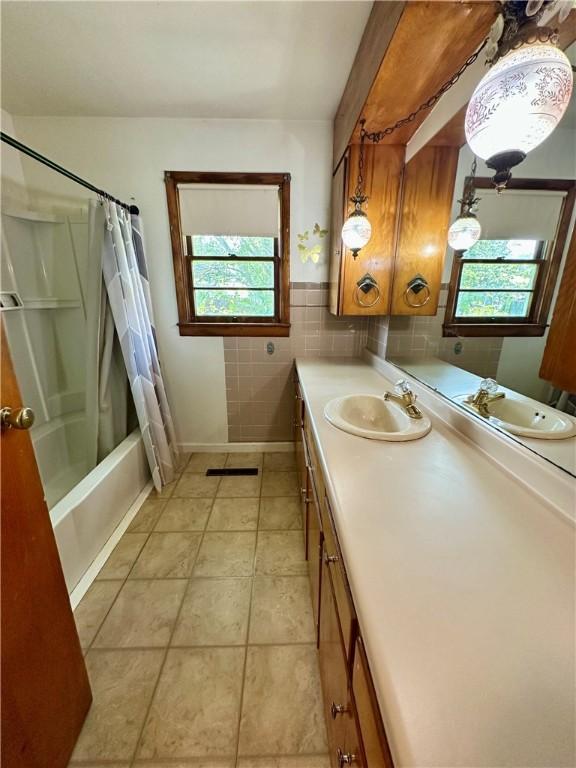 1321 Rudy Ave, Mattoon, IL 61938 - bathroom with vanity, tile patterned flooring, shower / bath combo, and tile walls