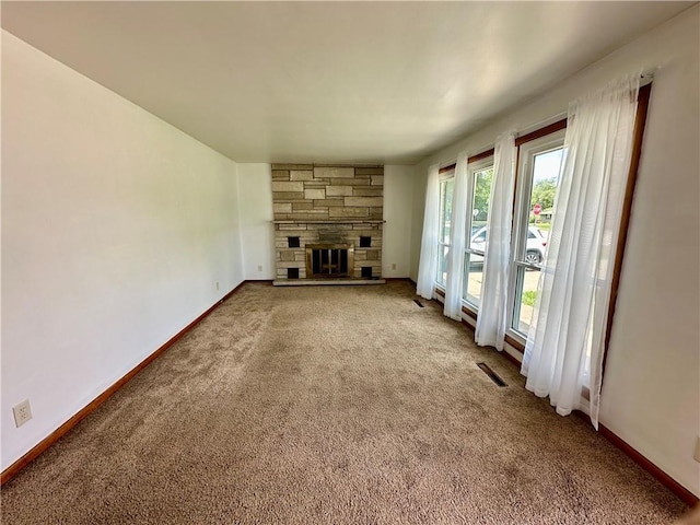 1321 Rudy Ave, Mattoon, IL 61938 - unfurnished living room with carpet flooring and a stone fireplace