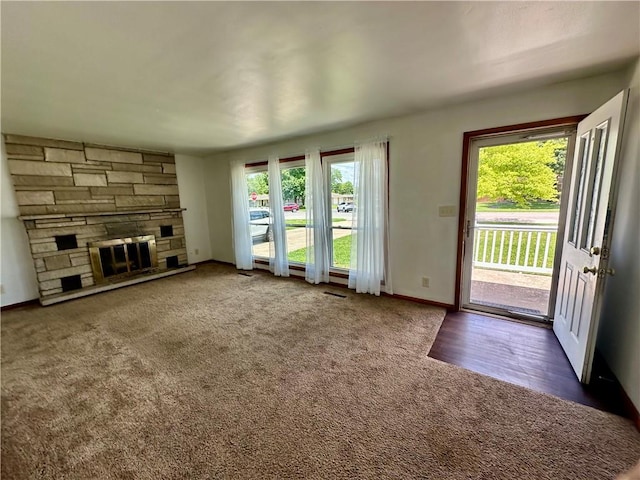 1321 Rudy Ave, Mattoon, IL 61938 - unfurnished living room featuring carpet and a stone fireplace