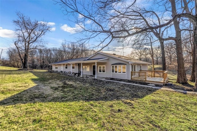 view of front of house featuring a deck and a front lawn