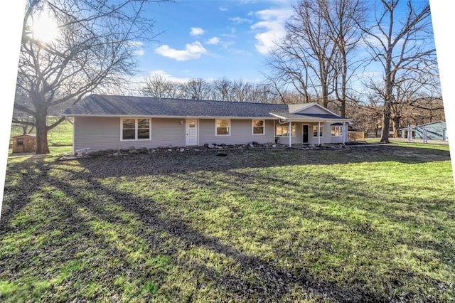 ranch-style house featuring a porch and a front yard