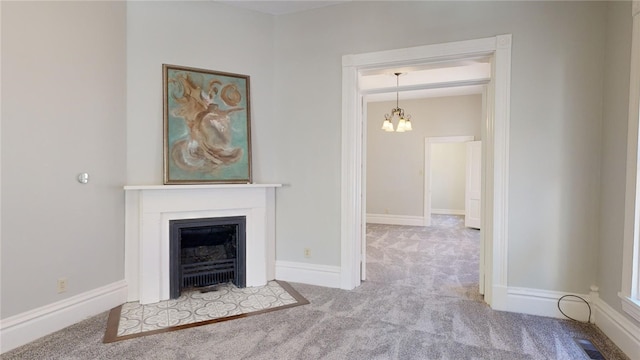 unfurnished living room featuring a chandelier and light colored carpet