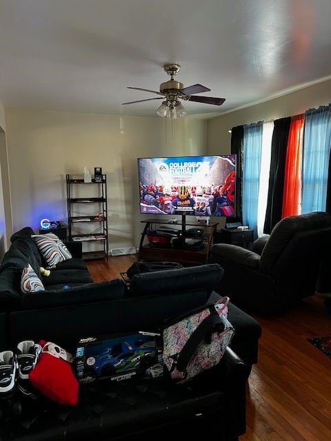 living room with wood-type flooring and ceiling fan