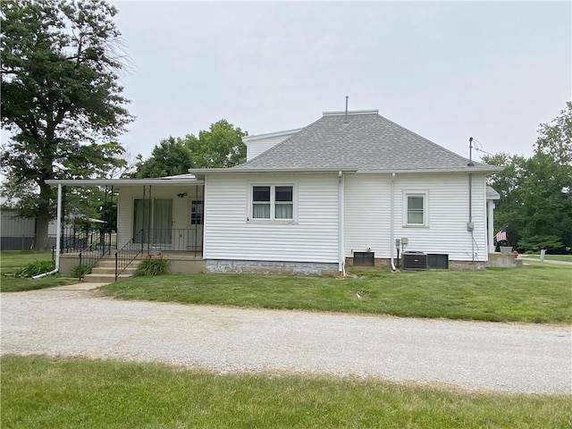 828 S Indiana St, Ashmore, IL 61912 - rear view of property featuring a yard, a shingled roof, and a porch