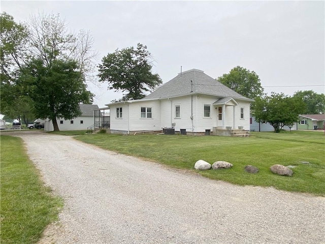 828 S Indiana St, Ashmore, IL 61912 - view of property exterior featuring a lawn and a shingled roof