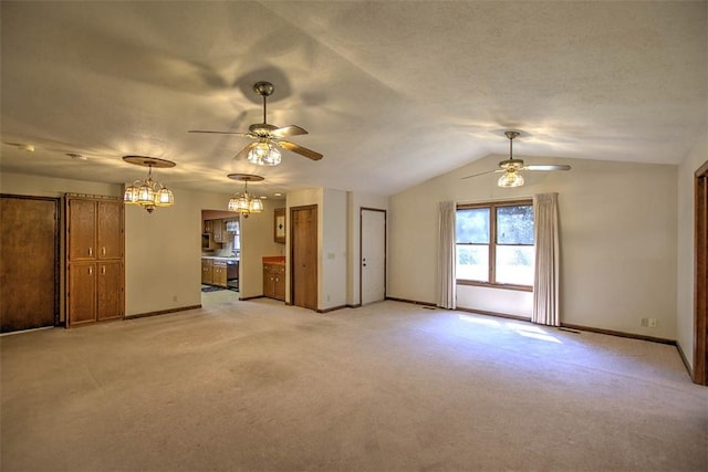 2839 E Wood St, Decatur, IL 62521 - unfurnished living room featuring baseboards, light colored carpet, and ceiling fan with notable chandelier