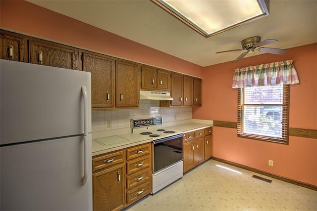 2839 E Wood St, Decatur, IL 62521 - kitchen with a ceiling fan, white appliances, light countertops, backsplash, and under cabinet range hood