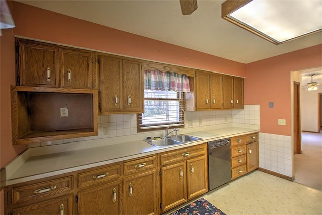 2839 E Wood St, Decatur, IL 62521 - kitchen with brown cabinets, light floors, dishwasher, a sink, and ceiling fan