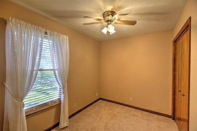 2839 E Wood St, Decatur, IL 62521 - unfurnished bedroom featuring light carpet, a ceiling fan, baseboards, and a closet