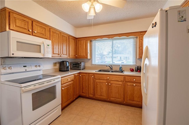 kitchen featuring a textured ceiling, ceiling fan, white appliances, and sink