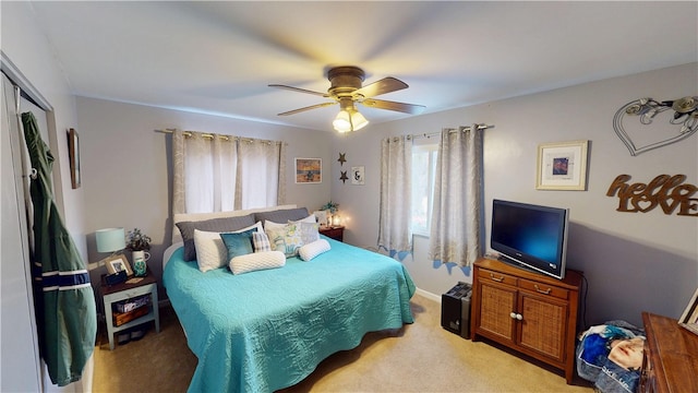 carpeted bedroom featuring a closet and ceiling fan