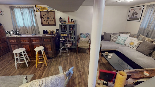 living room with dark wood-type flooring and bar area