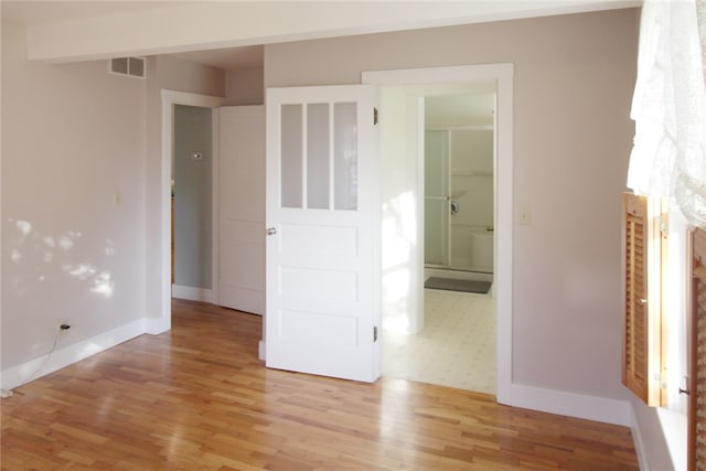 unfurnished room with light hardwood / wood-style flooring