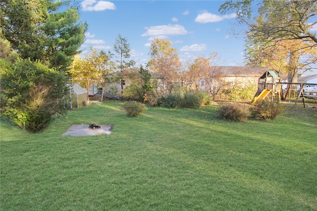 view of yard featuring an outbuilding and a playground