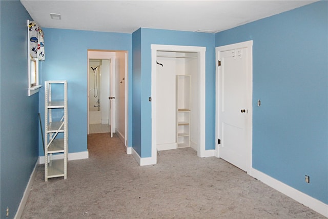 unfurnished bedroom featuring carpet floors and a closet