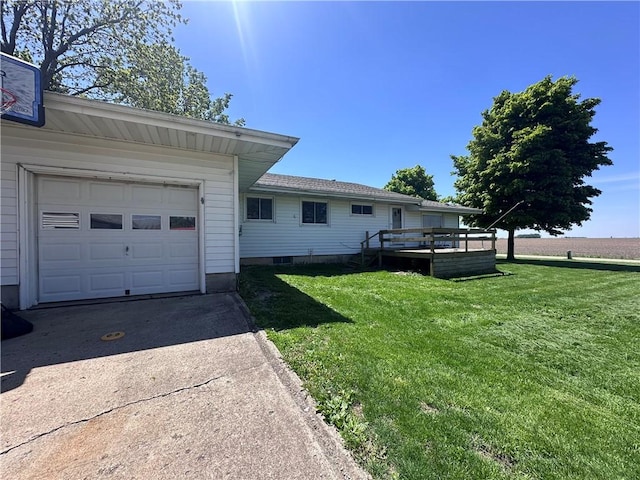 view of property exterior with a yard, concrete driveway, and a deck