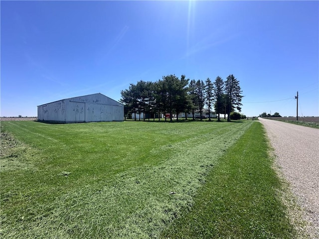view of green lawn with an outbuilding