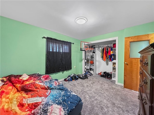 carpeted bedroom with baseboards and a closet