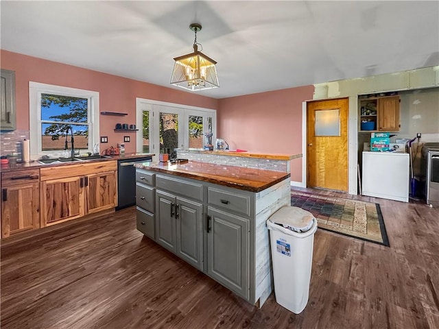 kitchen featuring dishwashing machine, gray cabinetry, a kitchen island, and open shelves